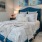 Bedroom with large bed, ensuite. queen bed and nightstands.